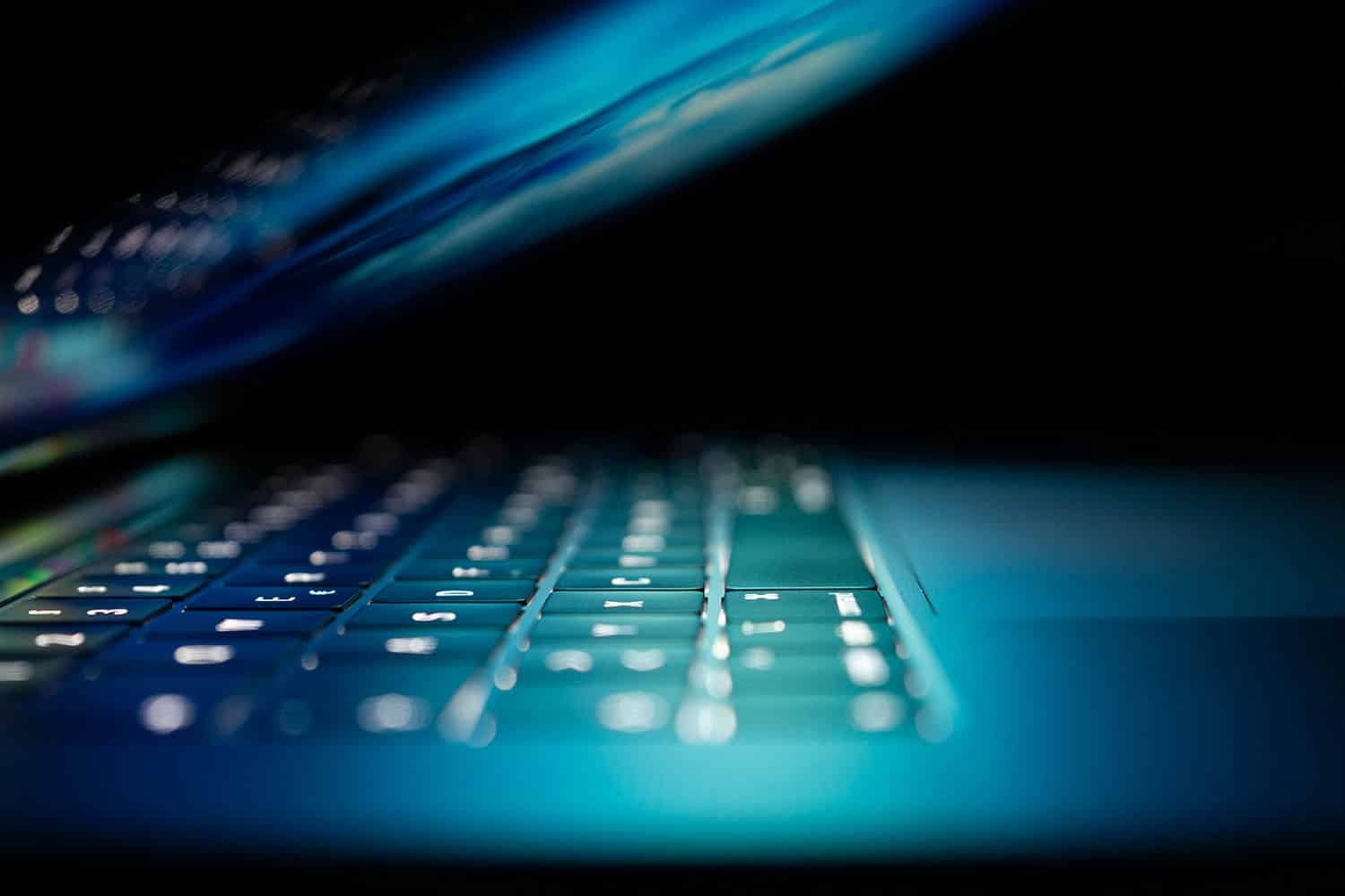 computer keyboard glowing in blue light
