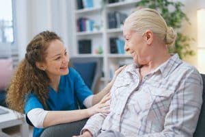 Home nurse smiling with patient