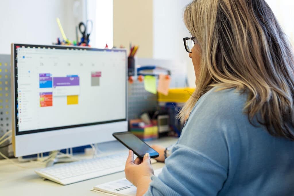 women using scheduling software on computer