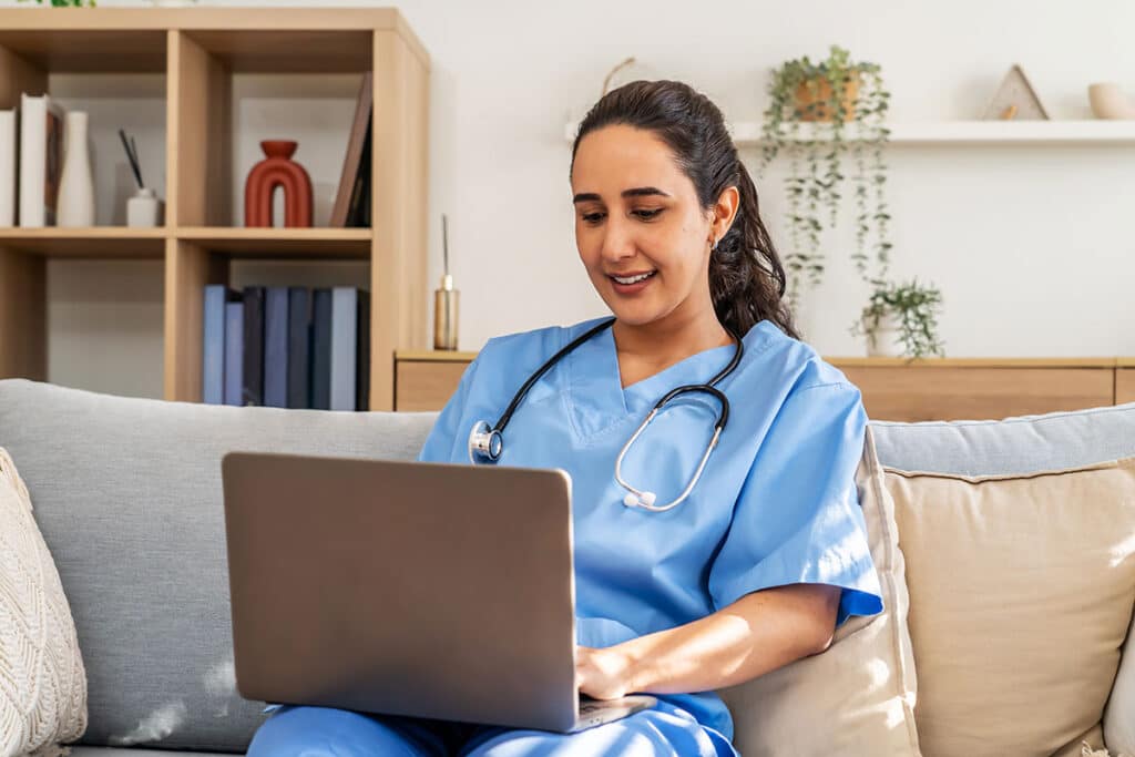 home care nurse working on laptop