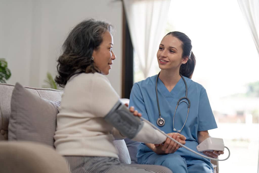Caregiver providing home care with patient