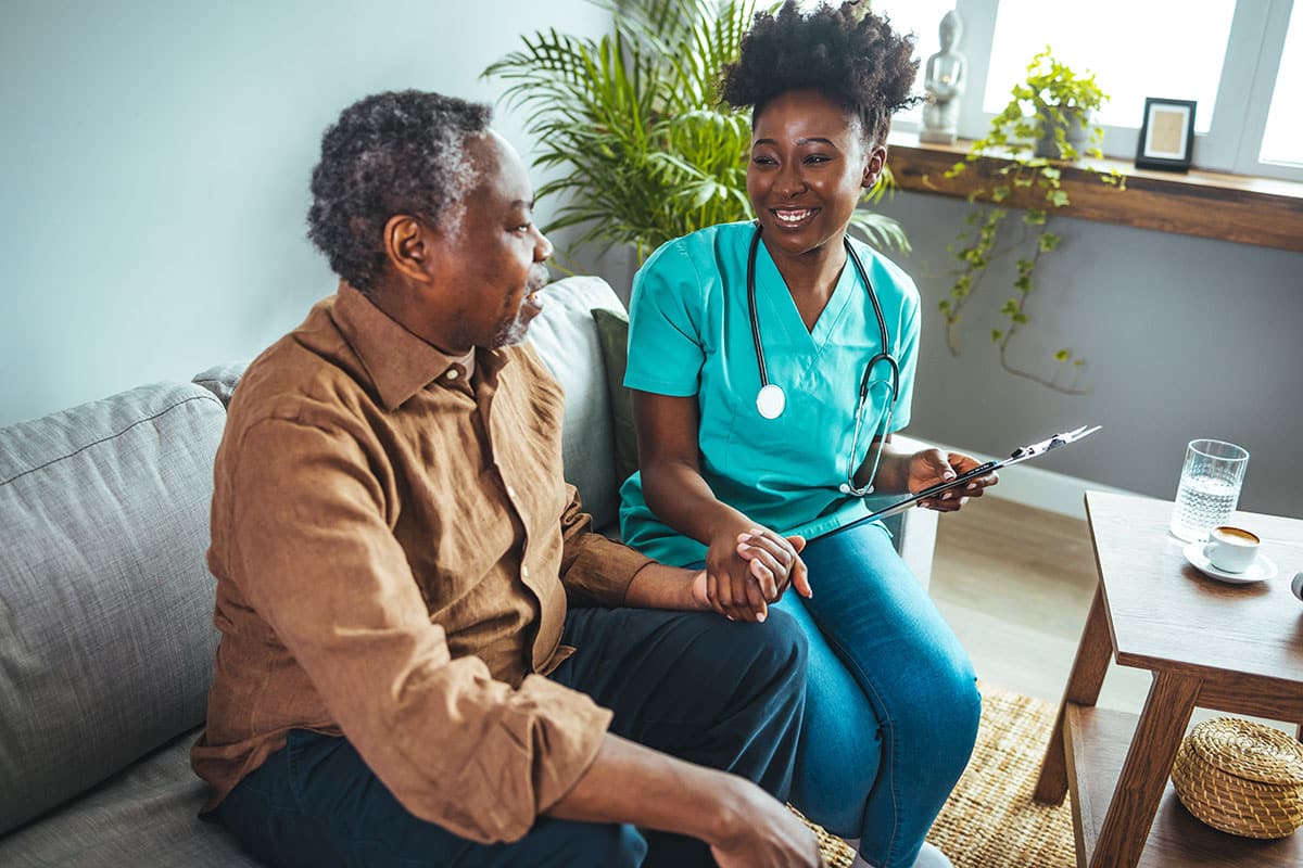 Caring Nurse Providing Compassionate Support to Elderly Patient at Home
