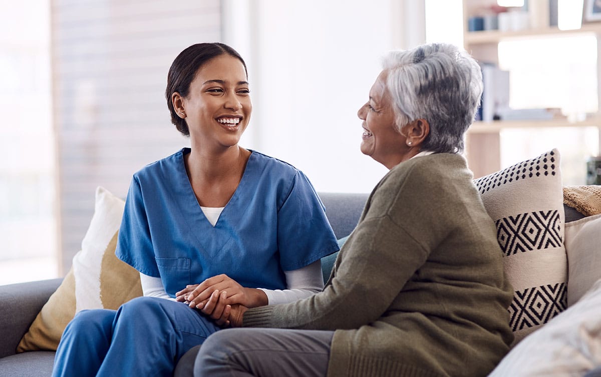 female caregiver with elderly patient for wellness, comfort and help